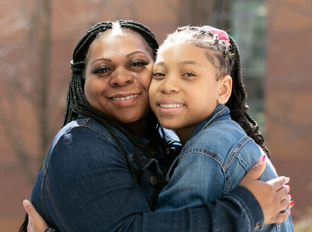 Harlem, a St. Louis Children’s patient, posing for a picture with her Mom.