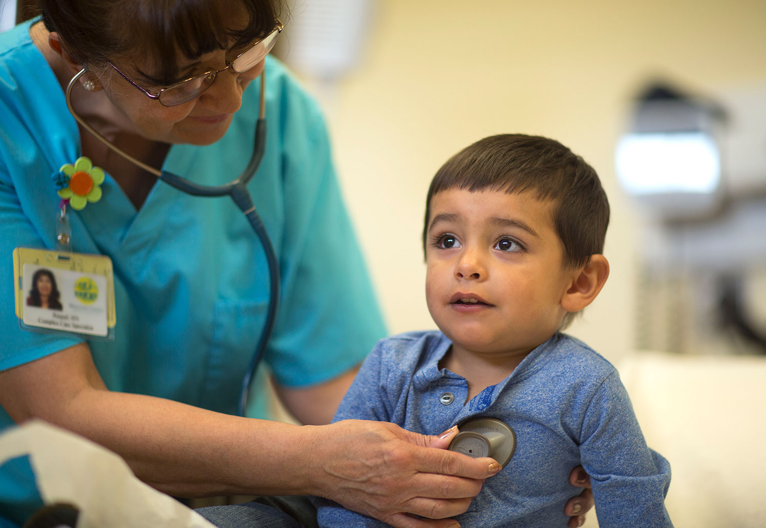 Child being evaluated by a stethoscope by a doctor