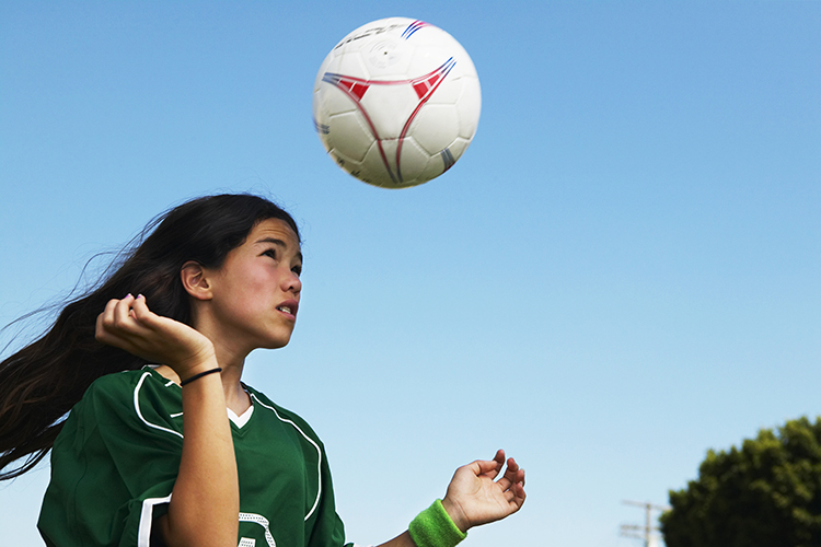 Young girl playing soccer