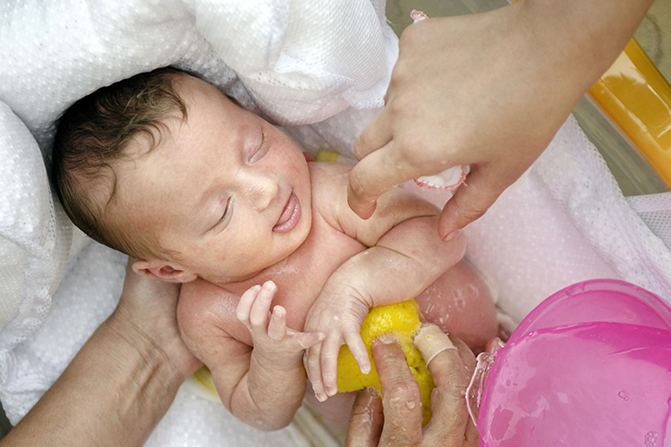 Baby being bathed