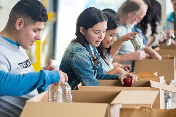 Group of people doing volunteer work, stocking boxes