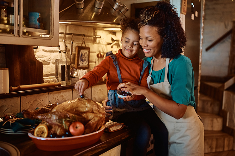 Mother and child prepping Thanksgiving dinner