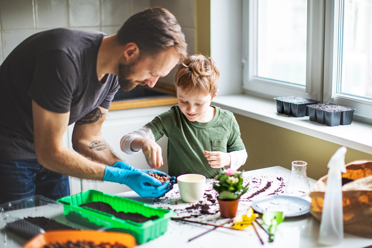 Father and son working on potting plants