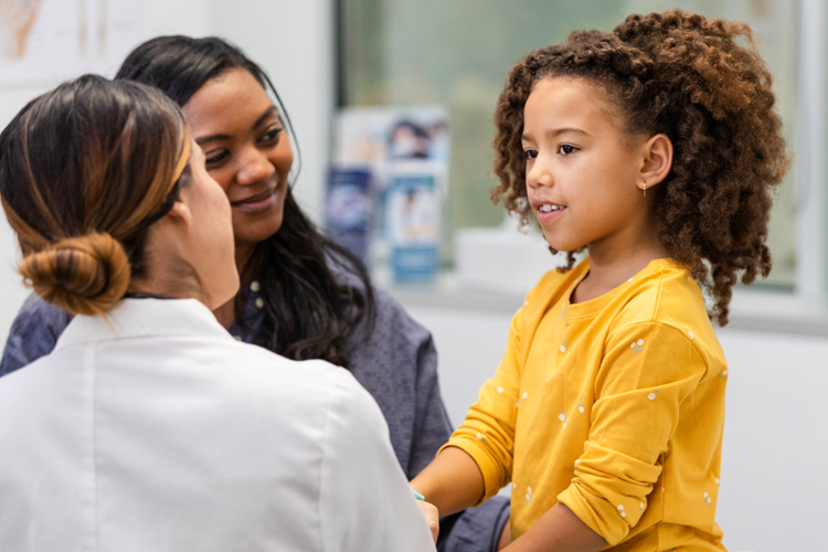 Mom and daughter with doctor at a doctor's visit