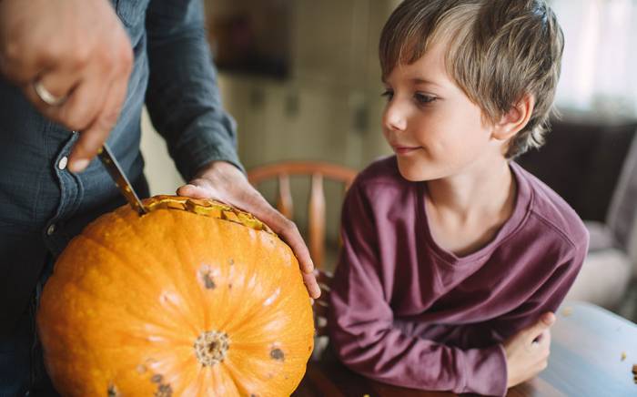 Halloween Safety - Child watching a pumpkin being carved