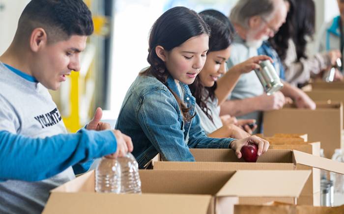 Group of people doing volunteer work, stocking boxes