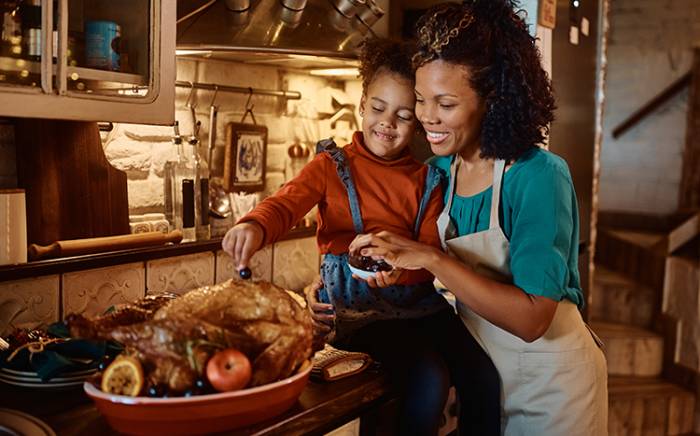 Mother and child prepping Thanksgiving dinner